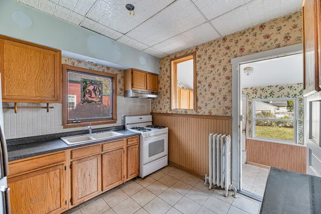a kitchen with a stove a sink and a refrigerator