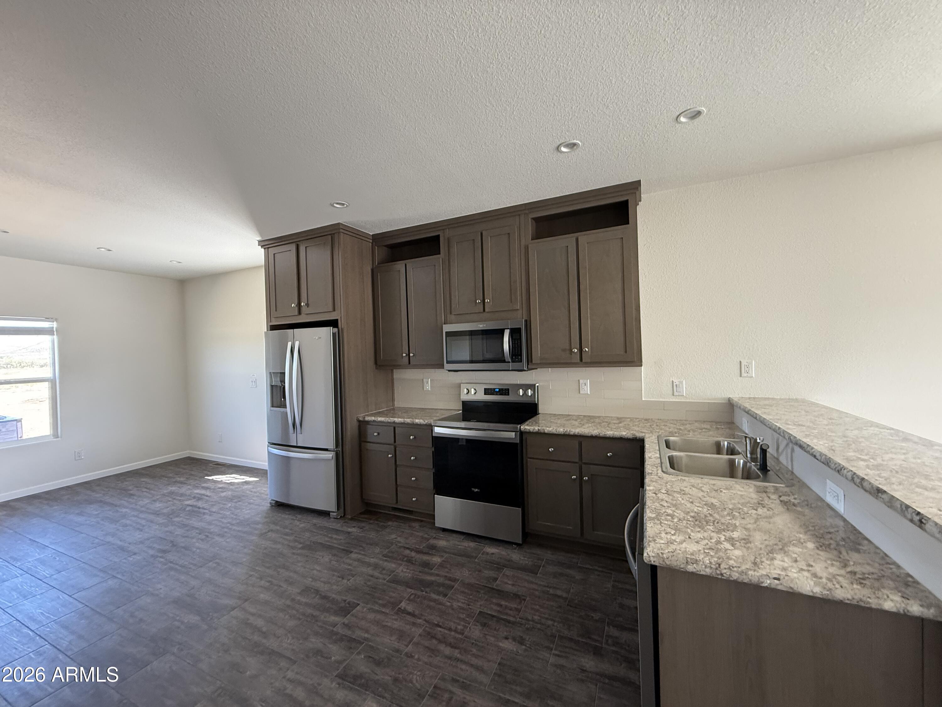 20 Ranch Drive Camp Verde, AZ 86322 - Photo 10 of 31 a kitchen with stainless steel appliances granite countertop a sink stove and refrigerator