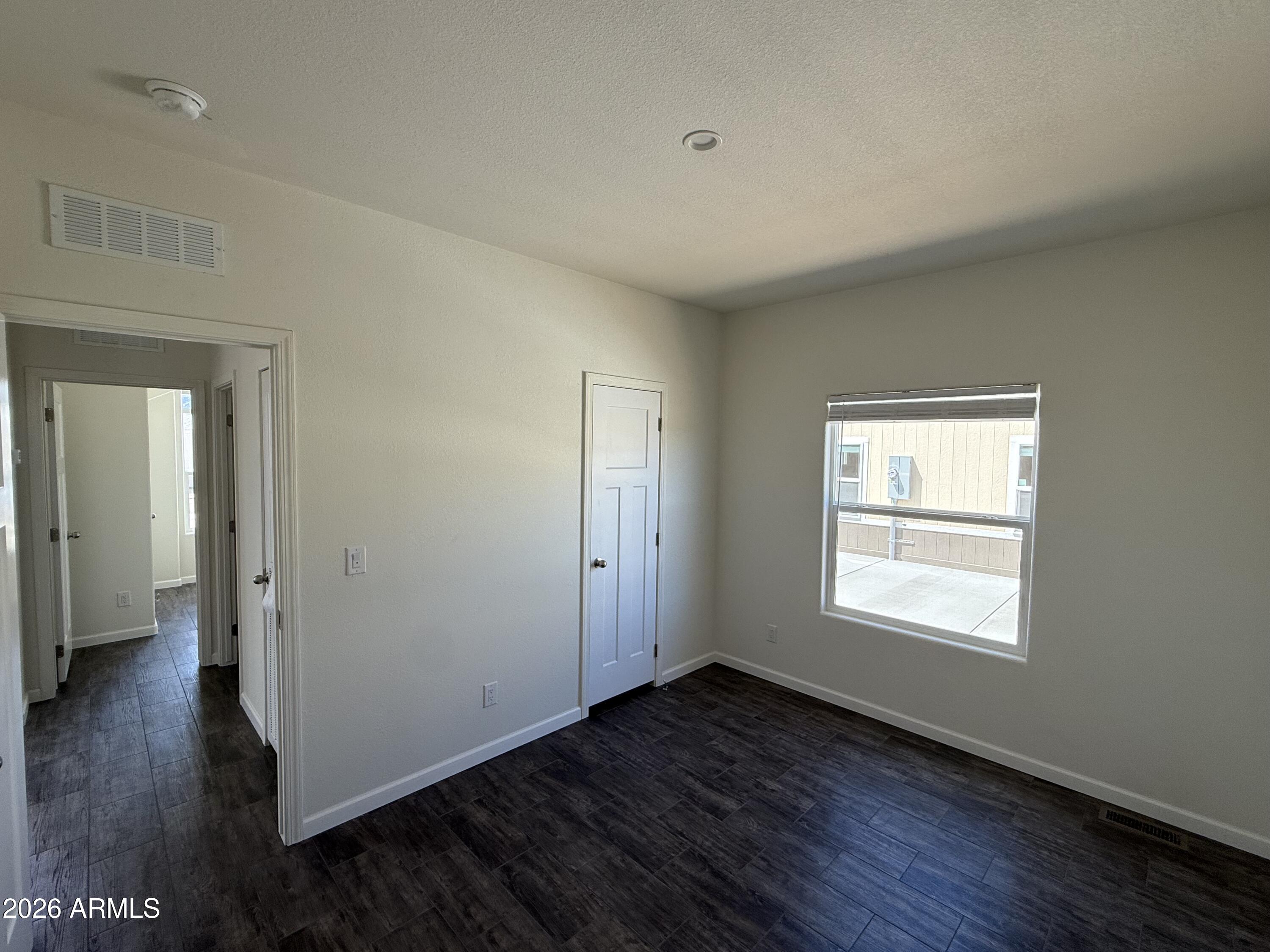 20 Ranch Drive Camp Verde, AZ 86322 - Photo 12 of 31 a view of an empty room with wooden floor and a window