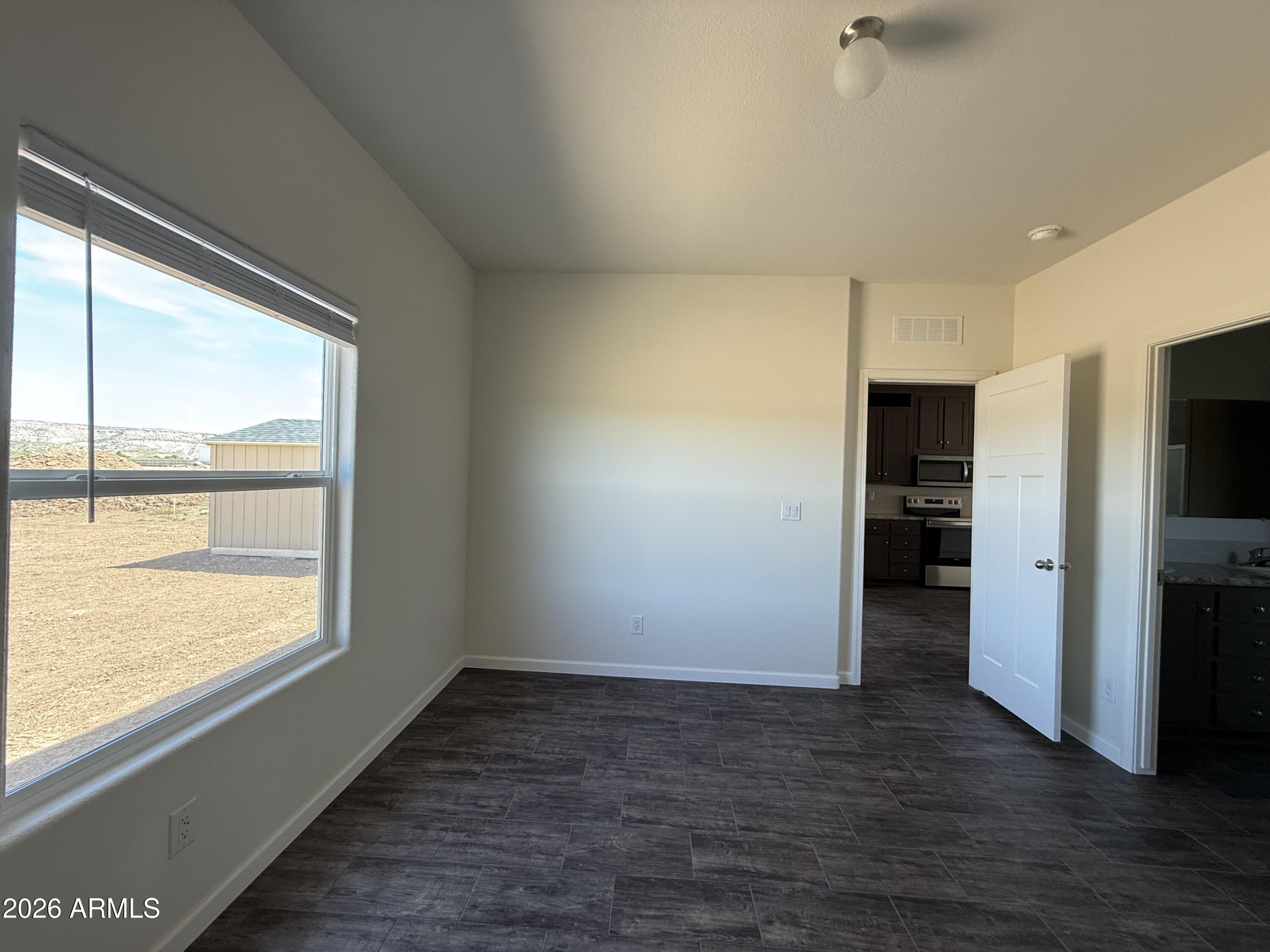 20 Ranch Drive Camp Verde, AZ 86322 - Photo 18 of 31 a view of an empty room with a window and a kitchen