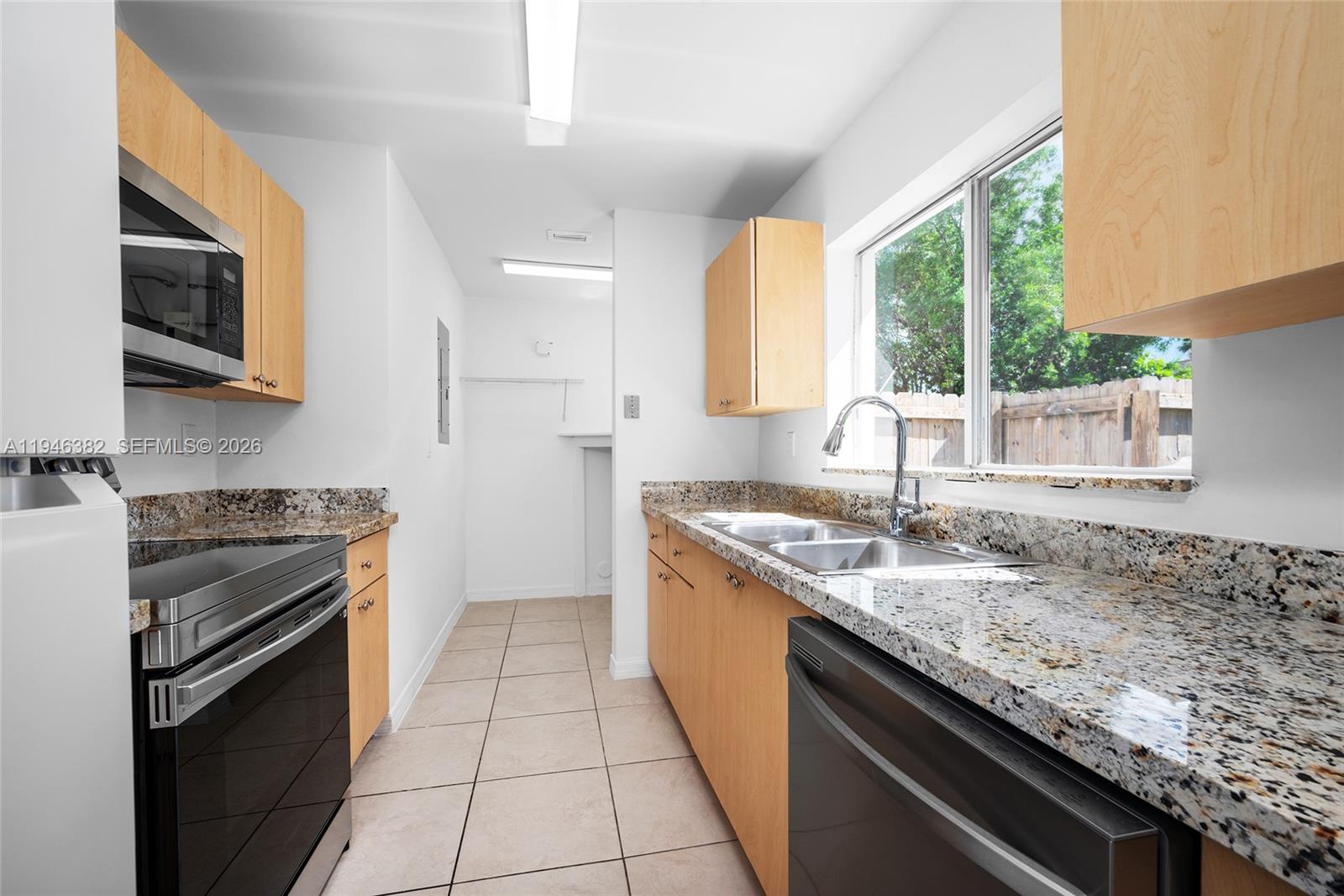 2275 Southwest 61st Avenue Miami, FL 33155 - Photo 11 of 53 a kitchen with granite countertop stainless steel appliances a stove sink and microwave