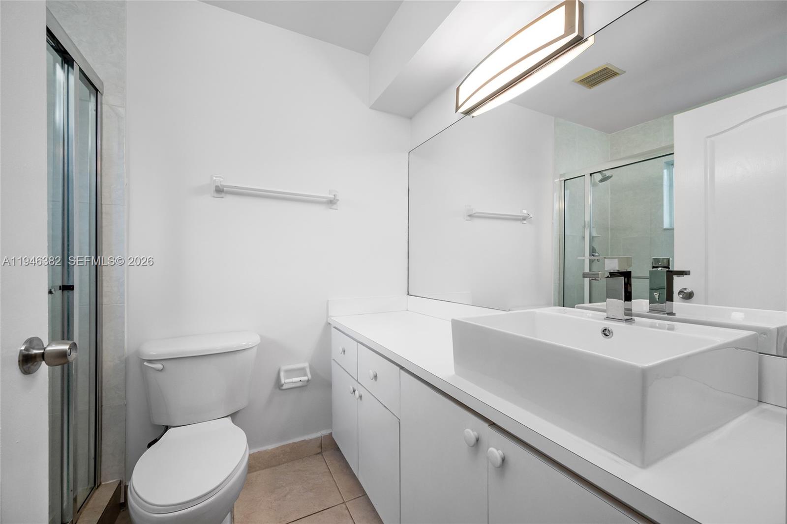 2275 Southwest 61st Avenue Miami, FL 33155 - Photo 17 of 53 a bathroom with a sink a toilet a mirror and vanity