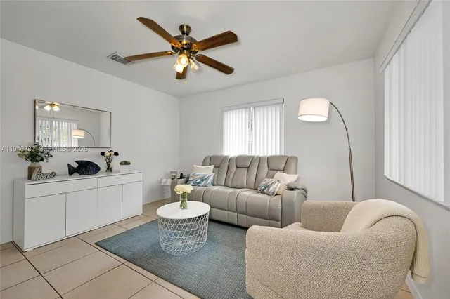 a living room with furniture and a large window