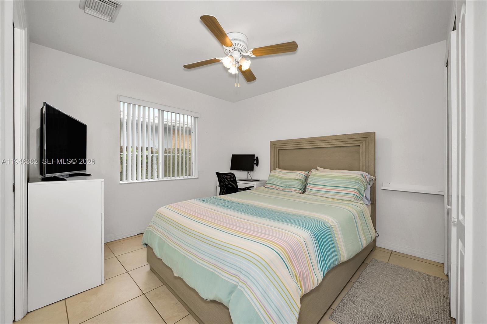 2275 Southwest 61st Avenue Miami, FL 33155 - Photo 39 of 53 a bedroom with a large bed and a flat screen tv