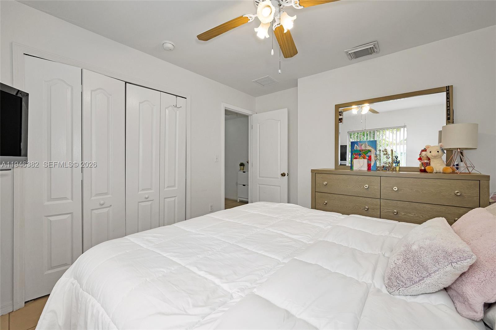 2275 Southwest 61st Avenue Miami, FL 33155 - Photo 40 of 53 a bedroom with a bed and a chandelier
