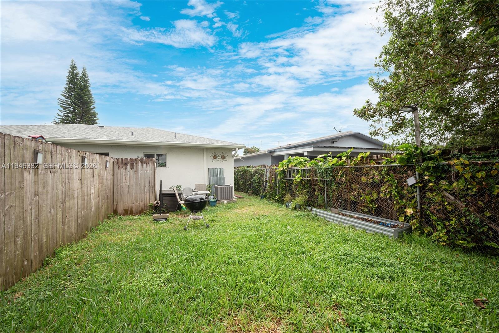 2275 Southwest 61st Avenue Miami, FL 33155 - Photo 45 of 53 a view of a chair and table in backyard of the house