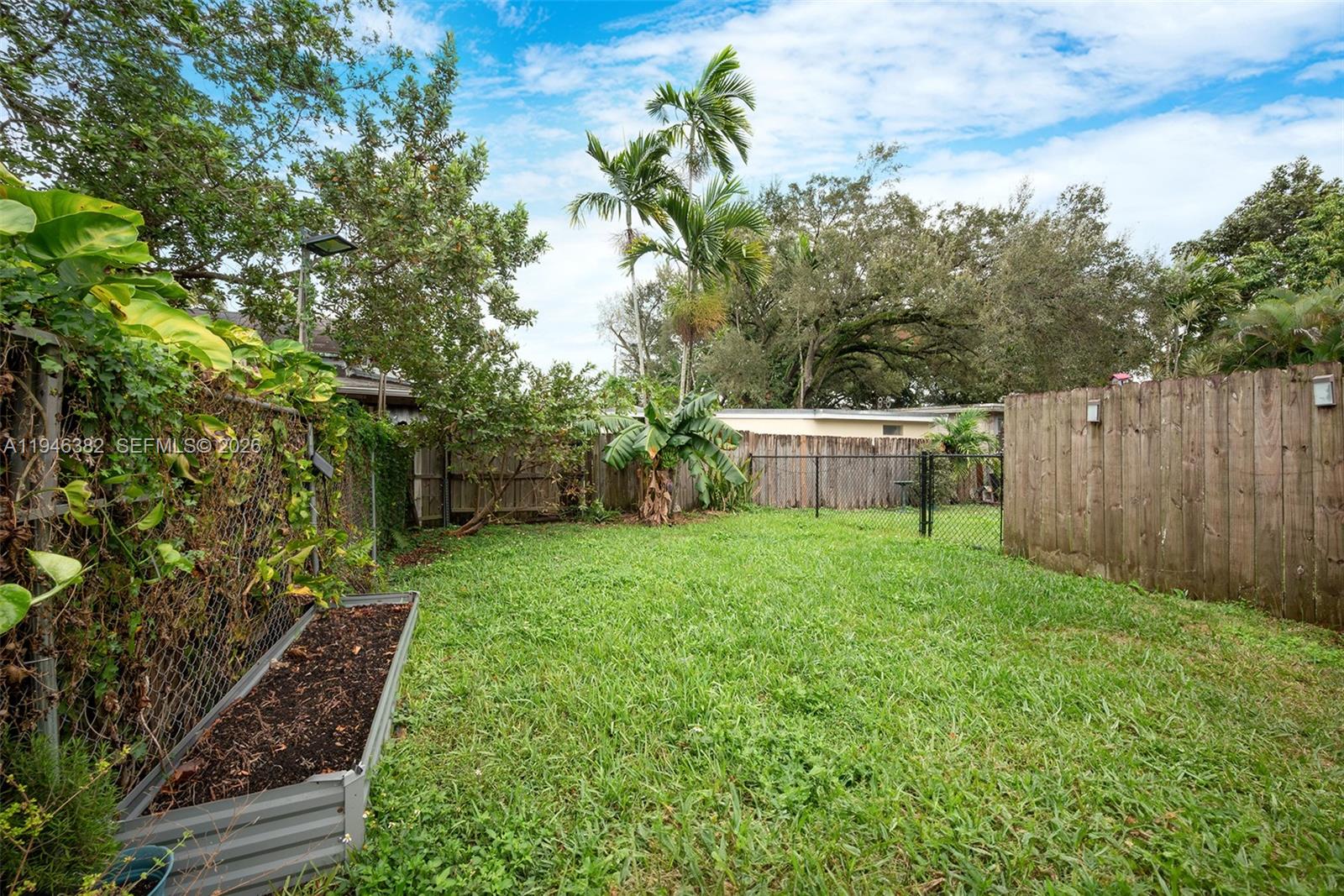 2275 Southwest 61st Avenue Miami, FL 33155 - Photo 46 of 53 a view of a backyard with potted plants and large trees