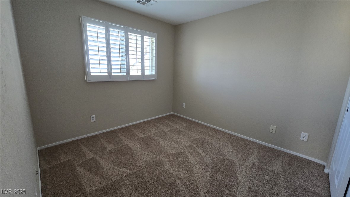 2737 Rimbaud Street Henderson, NV 89044 - Photo 28 of 49 Carpeted empty room with visible vents and baseboards