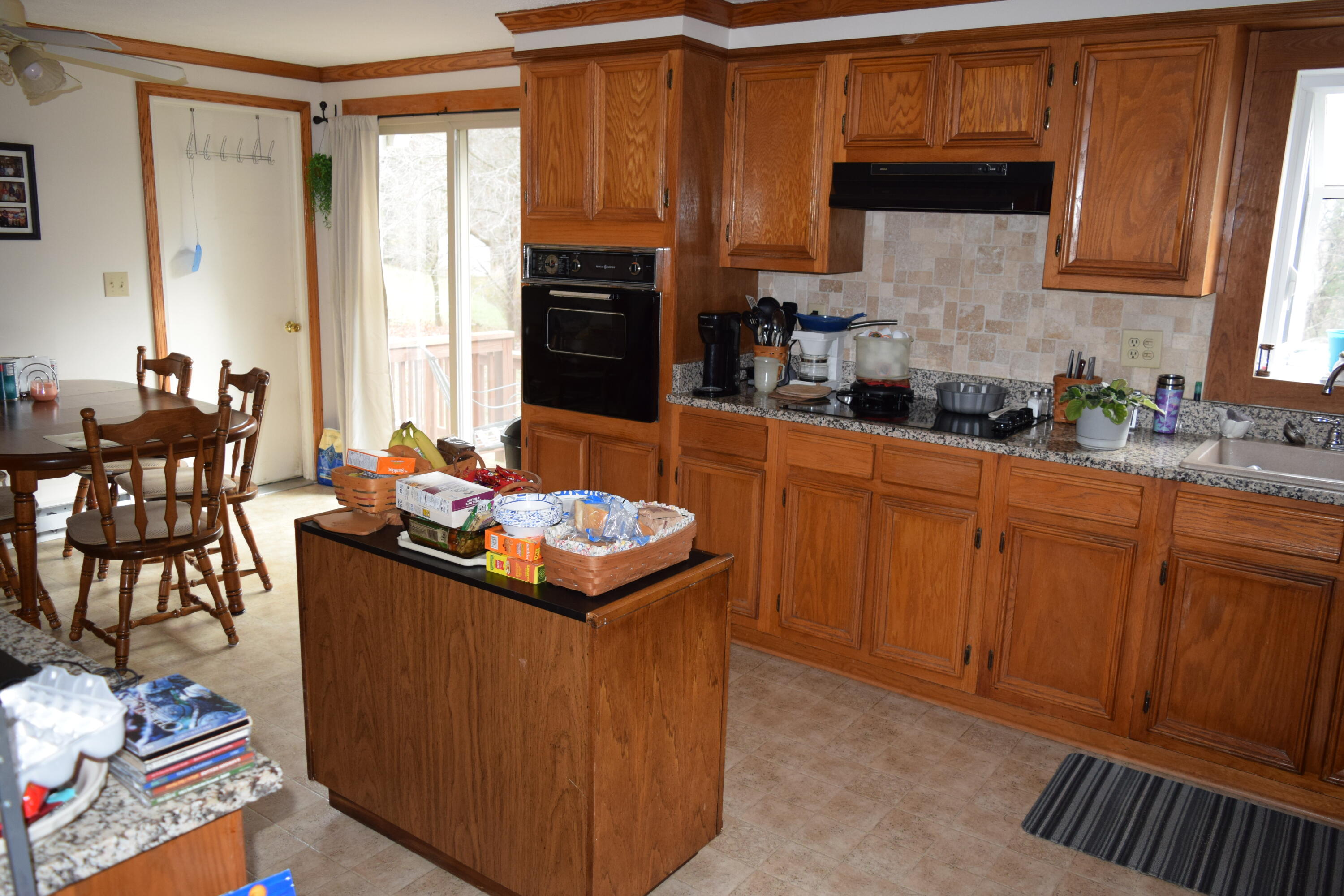 695 Long Level Road Southwest Floyd, VA 24091 - Photo 21 of 55 a kitchen with granite countertop a sink stove and cabinets