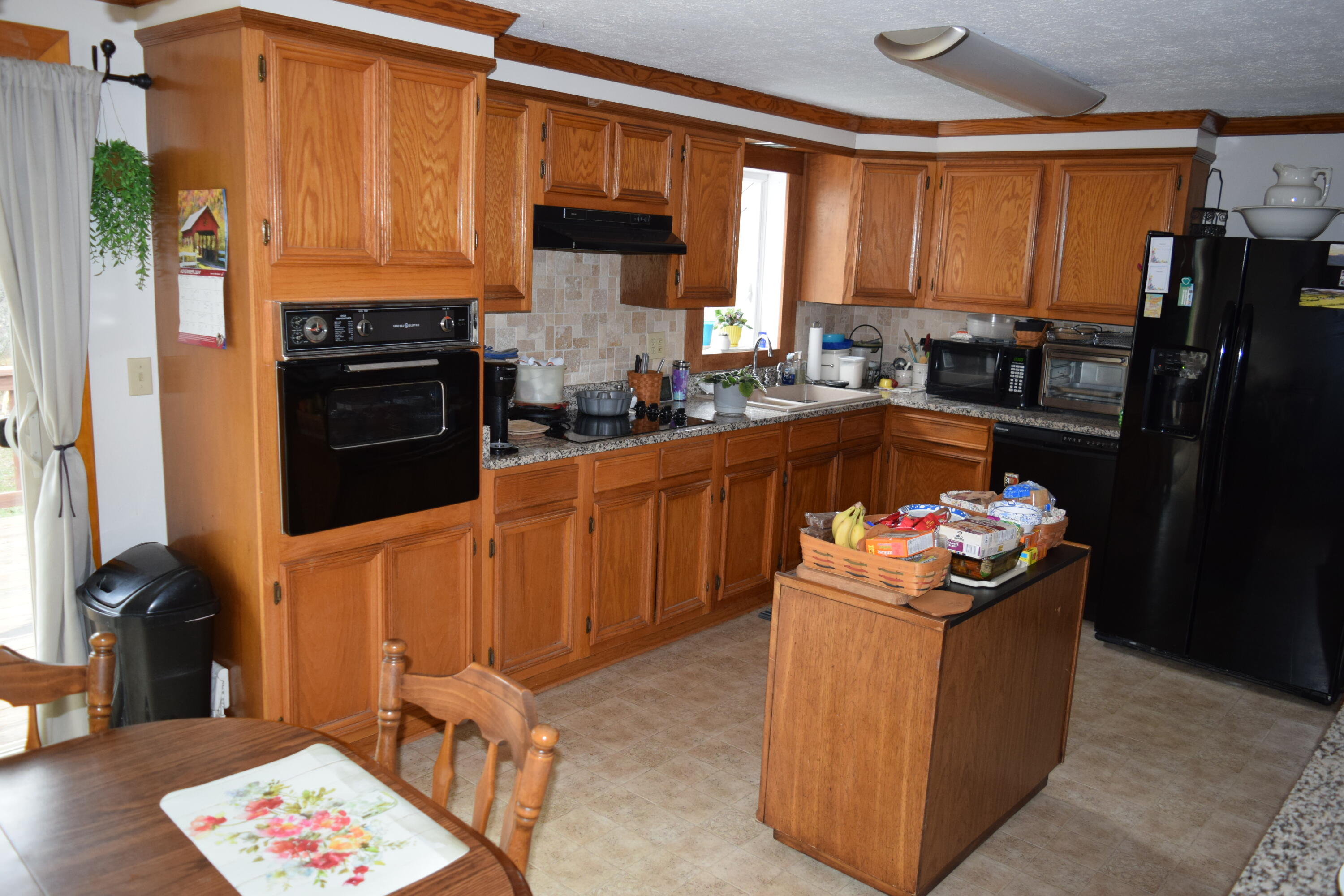 695 Long Level Road Southwest Floyd, VA 24091 - Photo 23 of 55 a kitchen with stainless steel appliances granite countertop a stove refrigerator sink and dishwasher