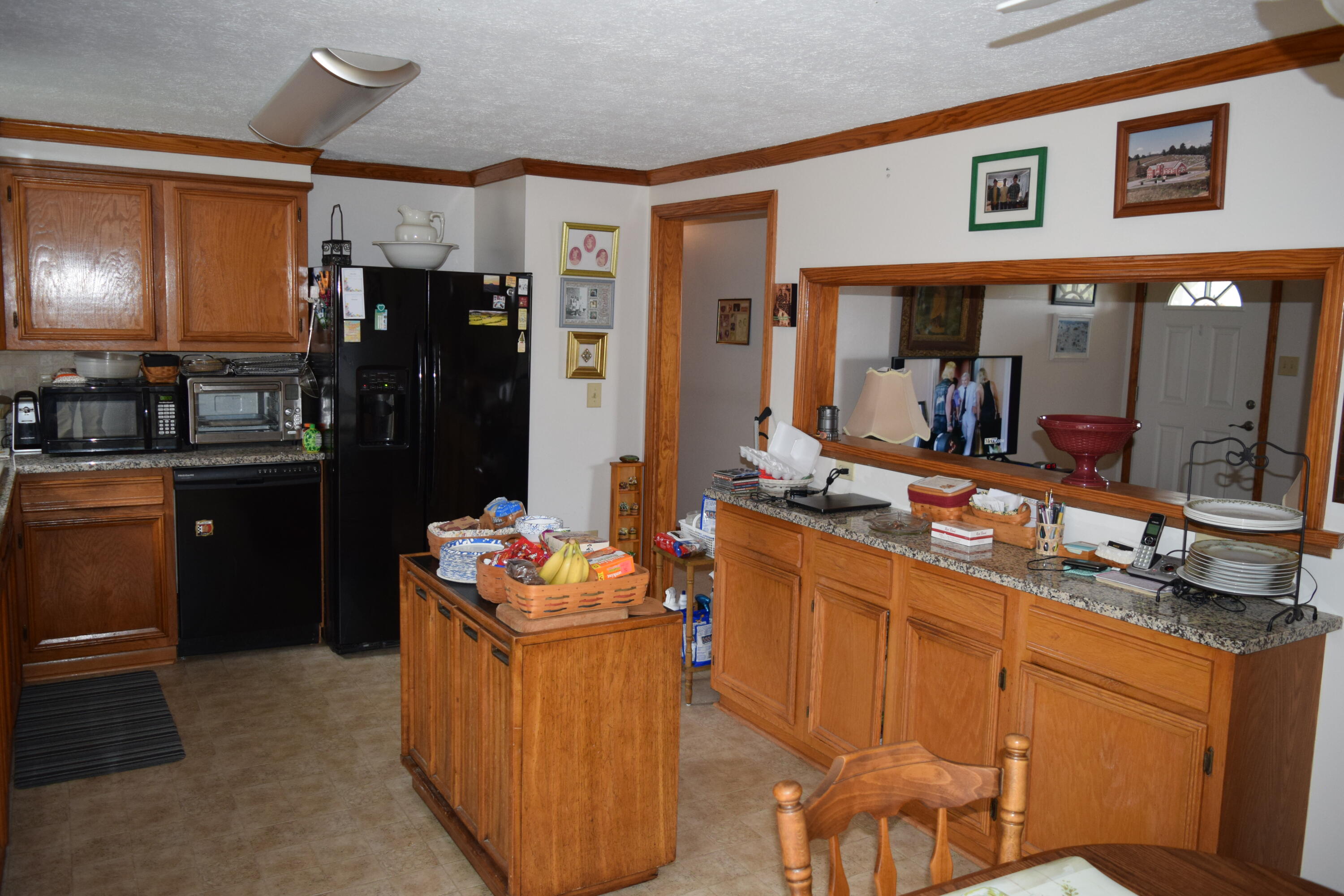695 Long Level Road Southwest Floyd, VA 24091 - Photo 24 of 55 a kitchen with stainless steel appliances kitchen island granite countertop a refrigerator and a stove