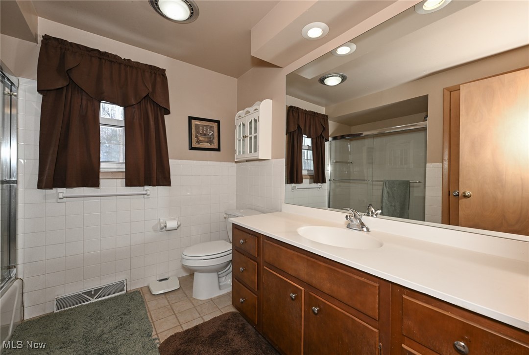 30875 Cannon Road Solon, OH 44139 - Photo 34 of 48 Full bathroom with vanity, ceramic flooring, tile walls