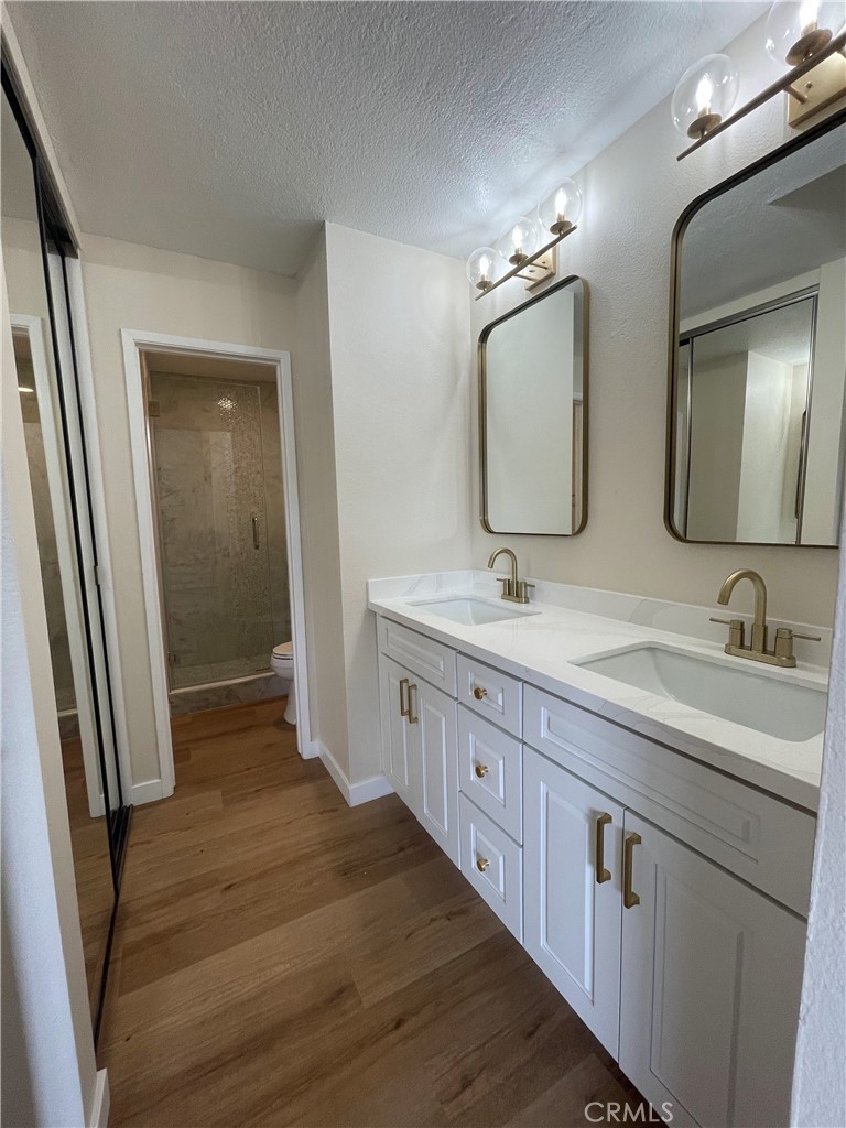 23 Sunfish, Unit 33 Irvine, CA 92604 - Photo 11 of 32 a bathroom with double vanity sink and a mirror
