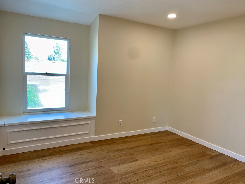 23 Sunfish, Unit 33 Irvine, CA 92604 - Photo 13 of 32 a view of empty room with wooden floor and fan