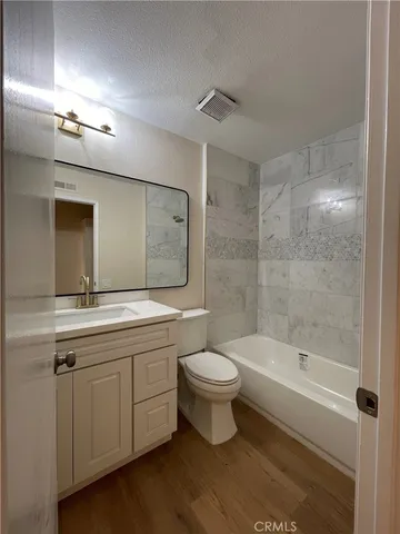 a bathroom with a double vanity sink toilet and shower