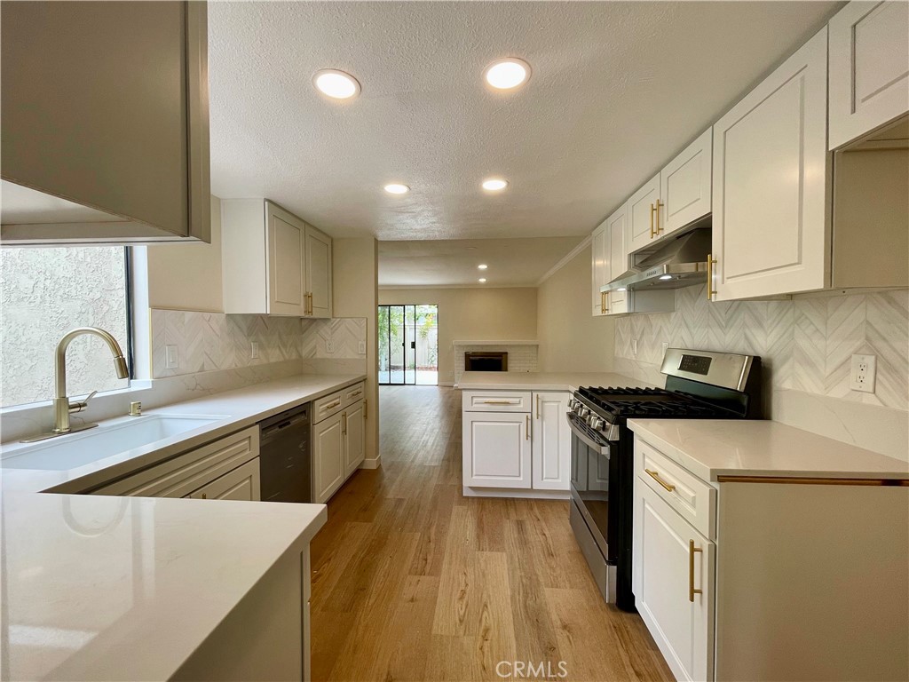 23 Sunfish, Unit 33 Irvine, CA 92604 - Photo 5 of 32 a kitchen with stainless steel appliances granite countertop a sink stove and refrigerator