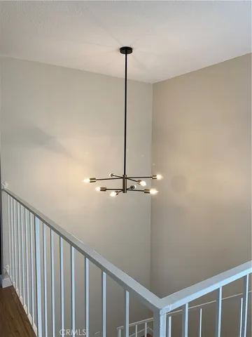 a view of a hallway with a ceiling fan