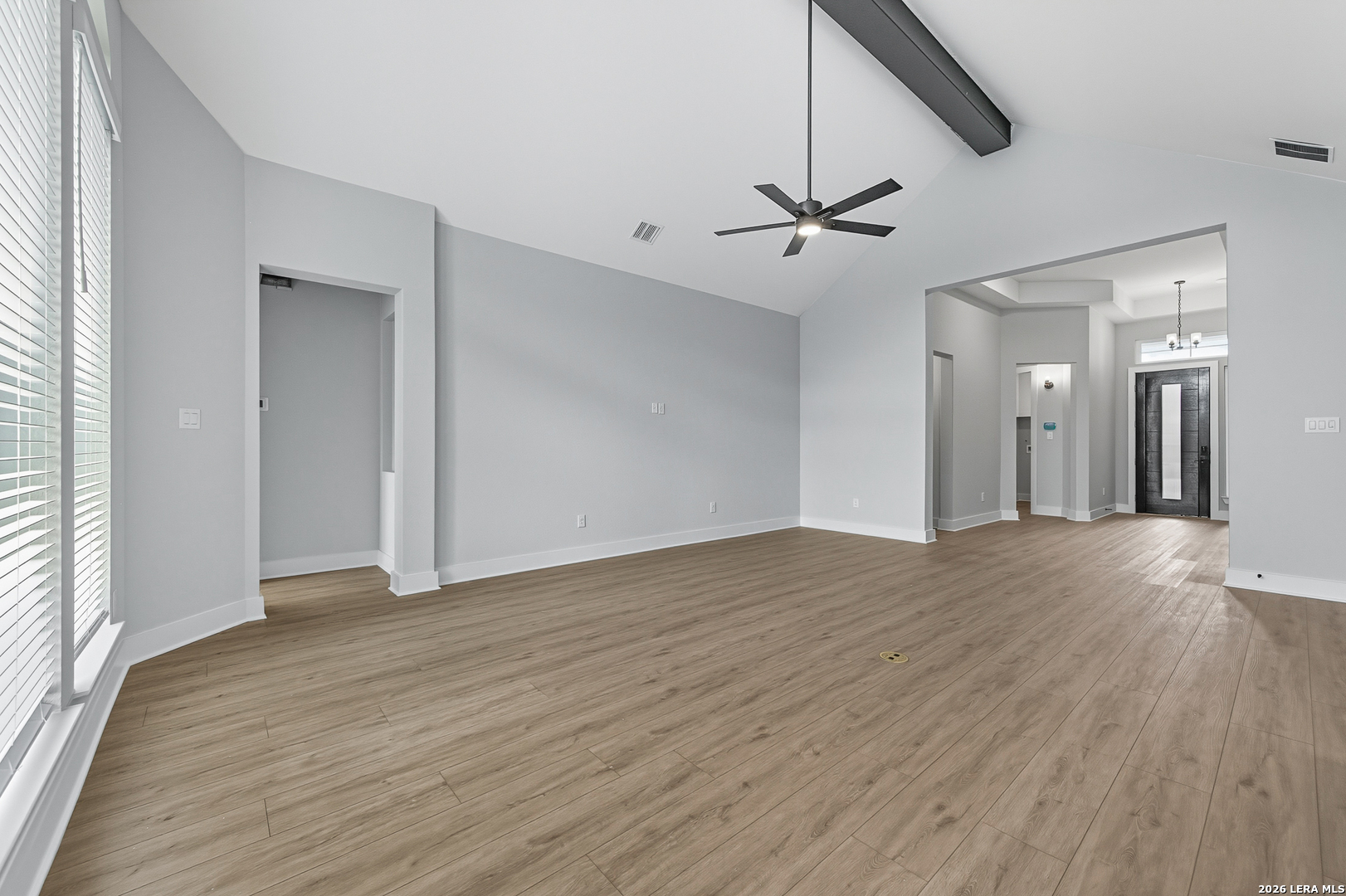 210 Kari Drive Castroville, TX 78009 - Photo 11 of 29 an empty room with wooden floor ceiling fan and windows