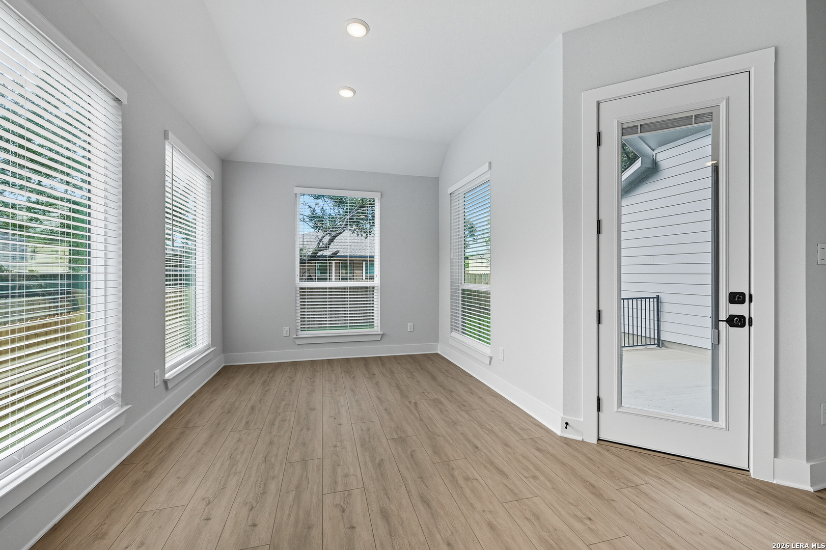 210 Kari Drive Castroville, TX 78009 - Photo 15 of 29 an empty room with wooden floor and windows
