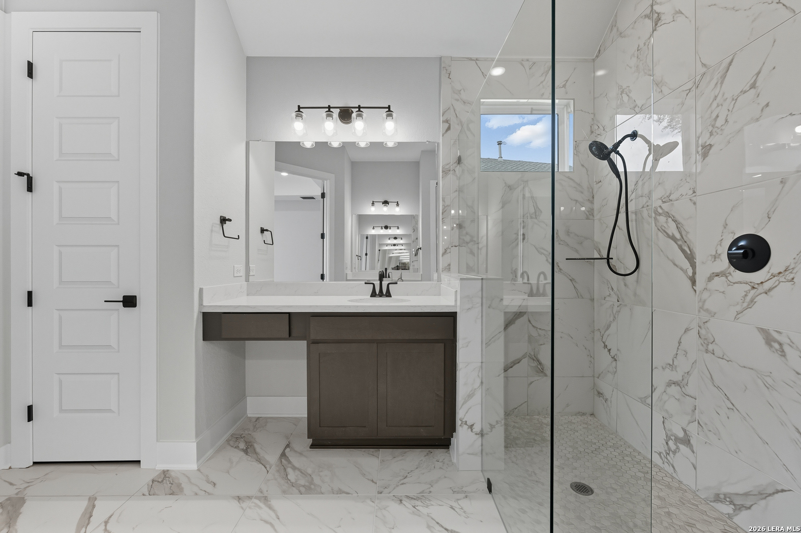 210 Kari Drive Castroville, TX 78009 - Photo 19 of 29 a bathroom with a double vanity sink a mirror and a shower