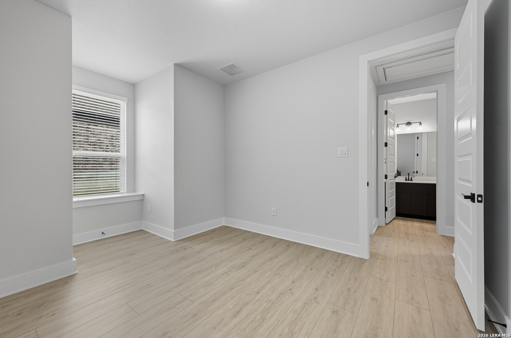 210 Kari Drive Castroville, TX 78009 - Photo 20 of 29 wooden floor in an empty room with a window