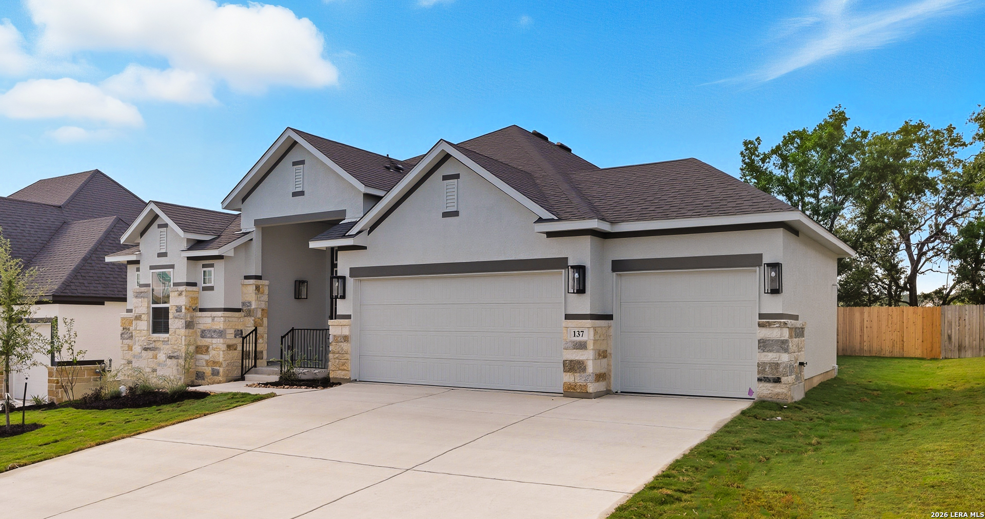 210 Kari Drive Castroville, TX 78009 - Photo 2 of 29 a view of a white house with a small yard and a large tree