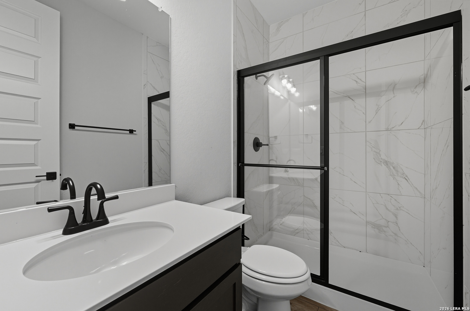 210 Kari Drive Castroville, TX 78009 - Photo 23 of 29 a bathroom with a sink and a mirror