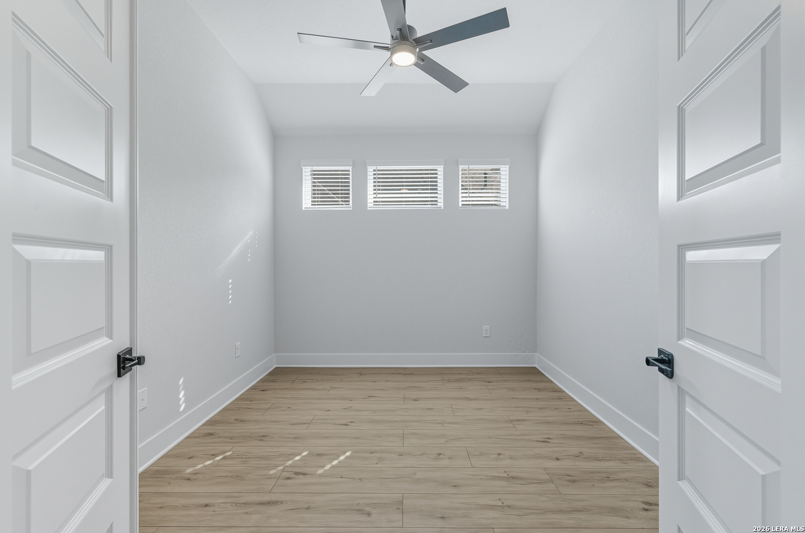 210 Kari Drive Castroville, TX 78009 - Photo 24 of 29 wooden floor in an empty room with a window