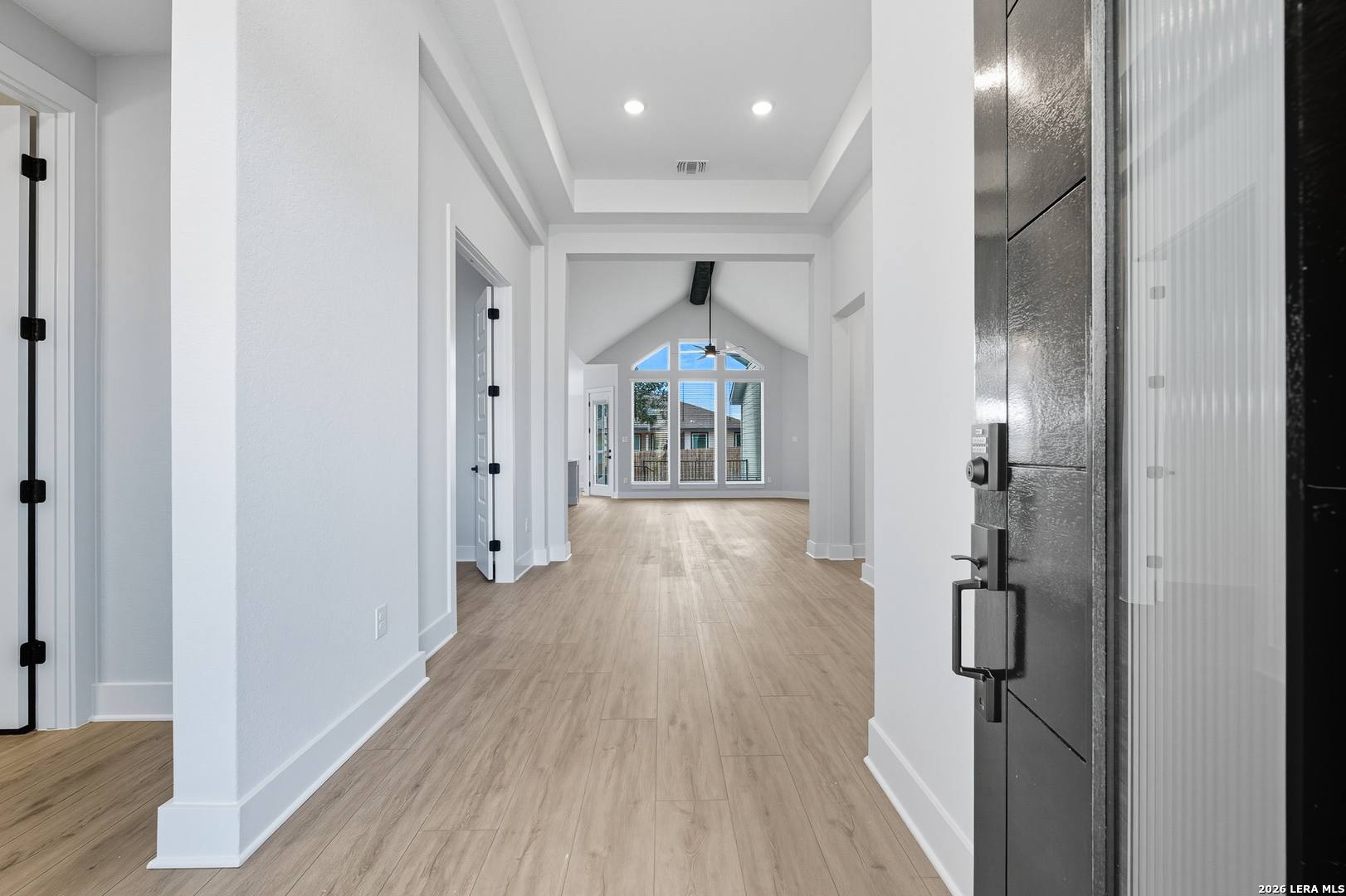 210 Kari Drive Castroville, TX 78009 - Photo 7 of 29 a hallway with wooden floor chandelier in a room
