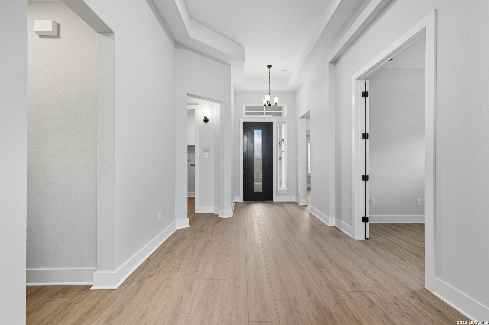 210 Kari Drive Castroville, TX 78009 - Photo 8 of 29 a view of a hallway with wooden floor