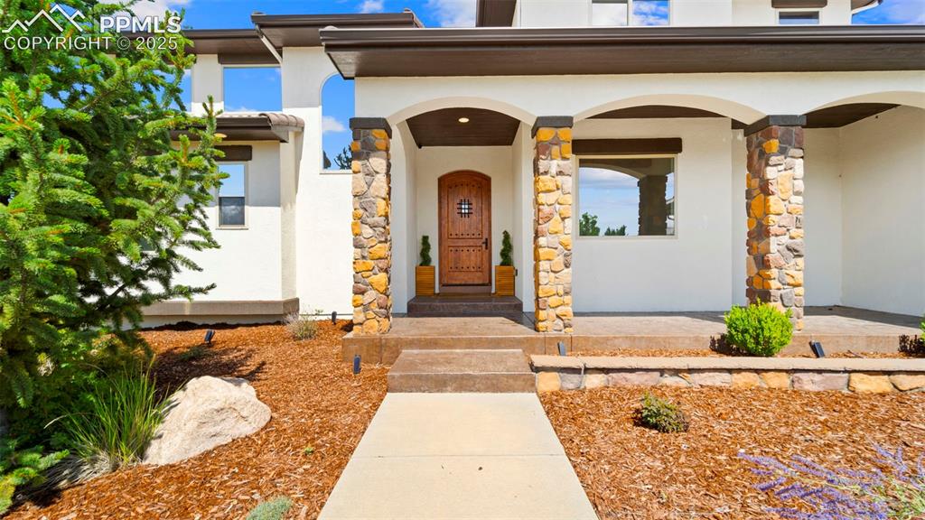 13625 Random Ridge View Colorado Springs, CO 80921 - Photo 4 of 50 Entrance to property featuring stucco siding