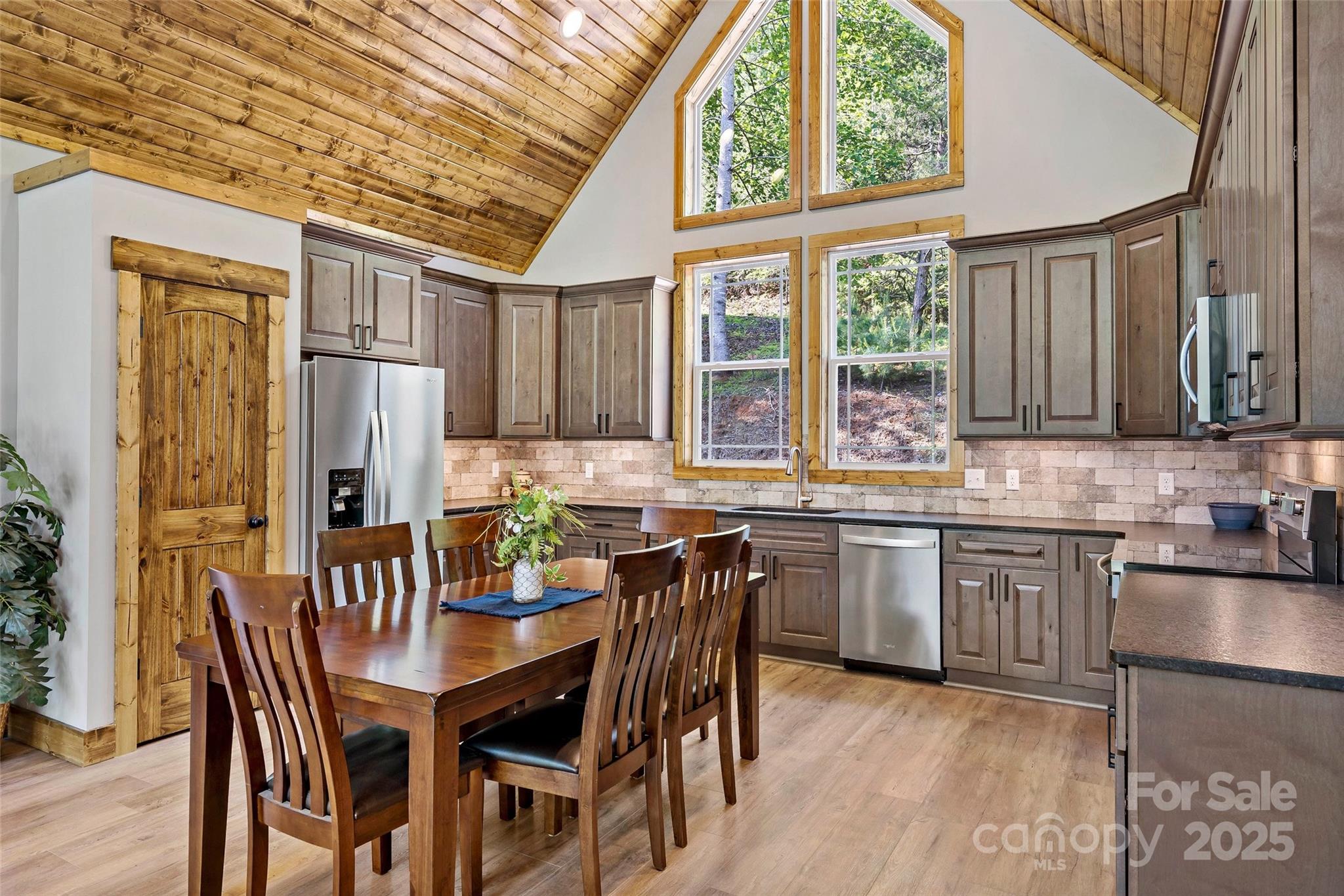 23 Laurel Crest Lane Mill Spring, NC 28756 - Photo 12 of 46 a kitchen with a table chairs refrigerator and cabinets