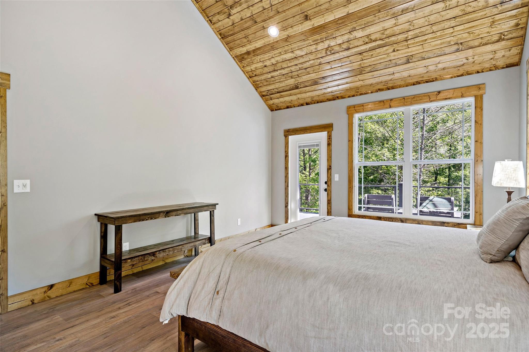 23 Laurel Crest Lane Mill Spring, NC 28756 - Photo 14 of 46 a bed sitting in a bedroom next to a window