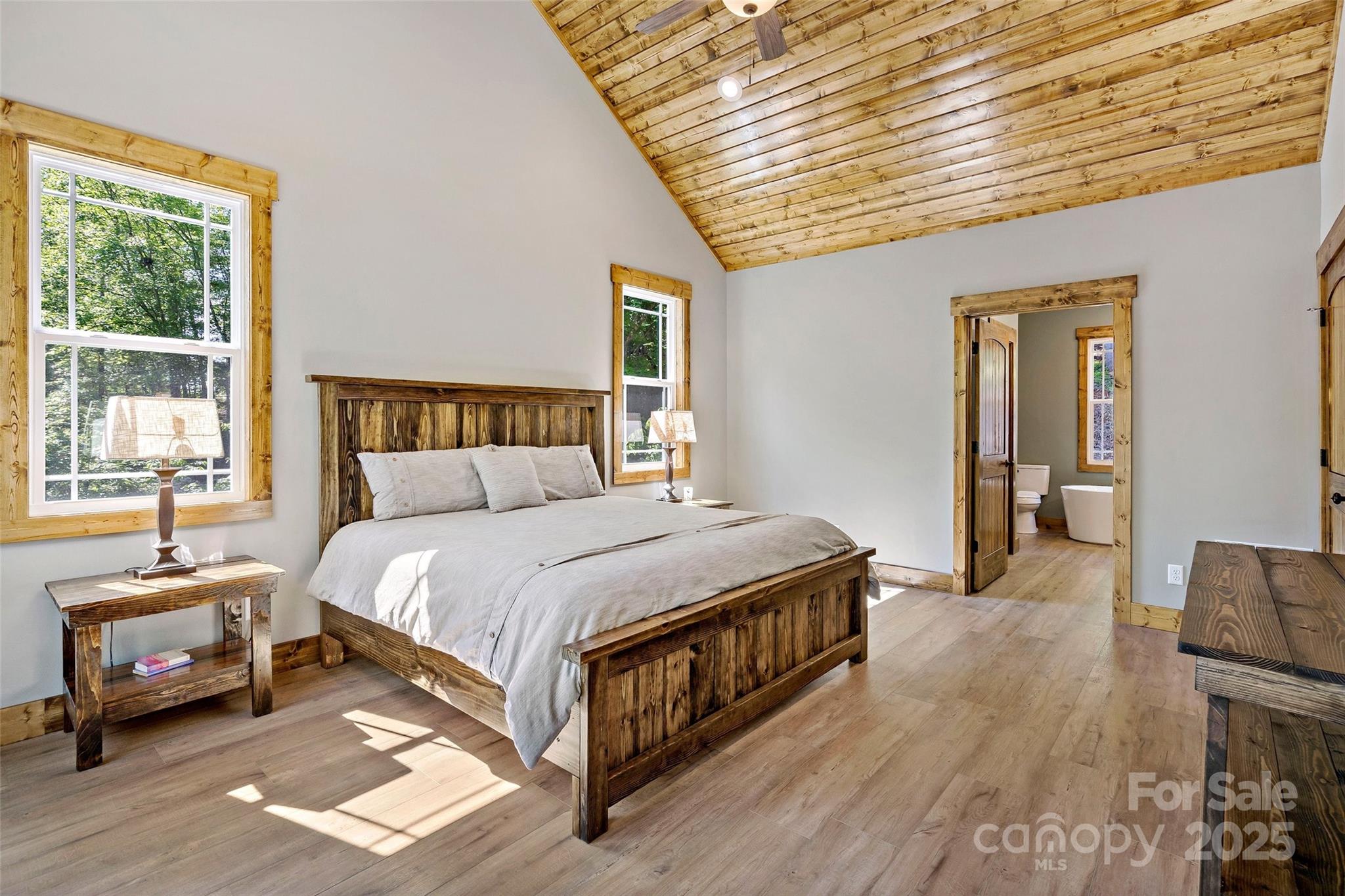 23 Laurel Crest Lane Mill Spring, NC 28756 - Photo 15 of 46 a bedroom with a bed and wooden floor