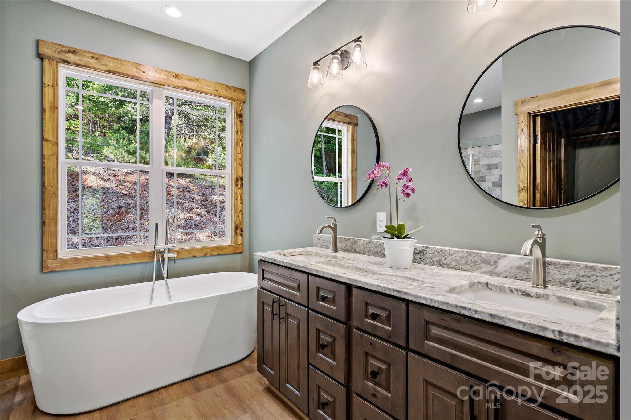 23 Laurel Crest Lane Mill Spring, NC 28756 - Photo 16 of 46 a bathroom with a tub a double vanity sink and mirror