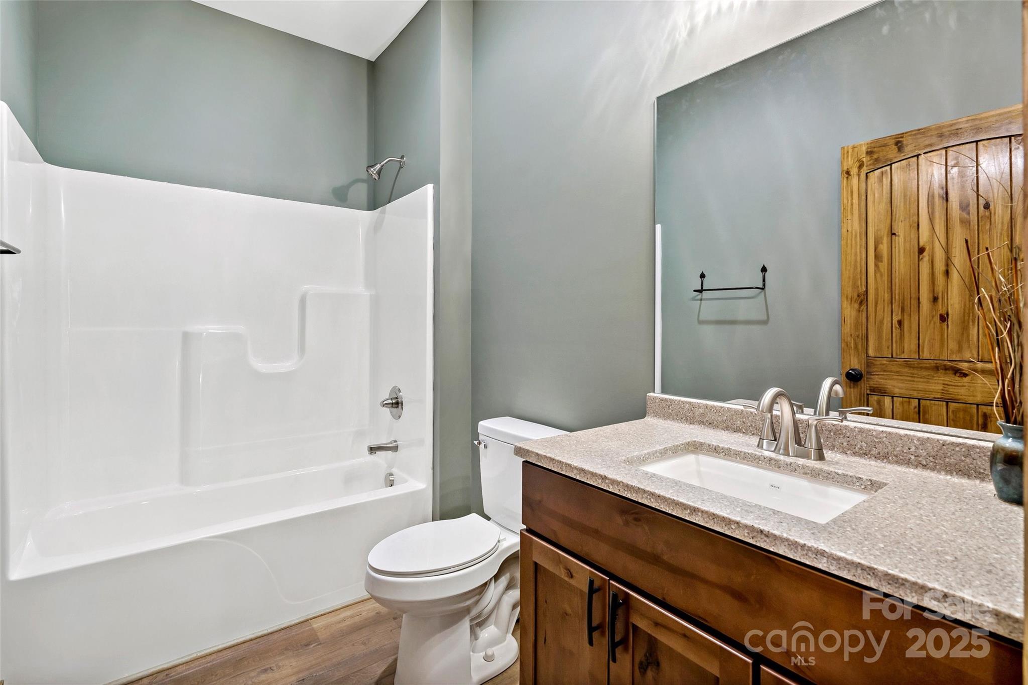 23 Laurel Crest Lane Mill Spring, NC 28756 - Photo 22 of 46 a bathroom with a granite countertop sink toilet and shower