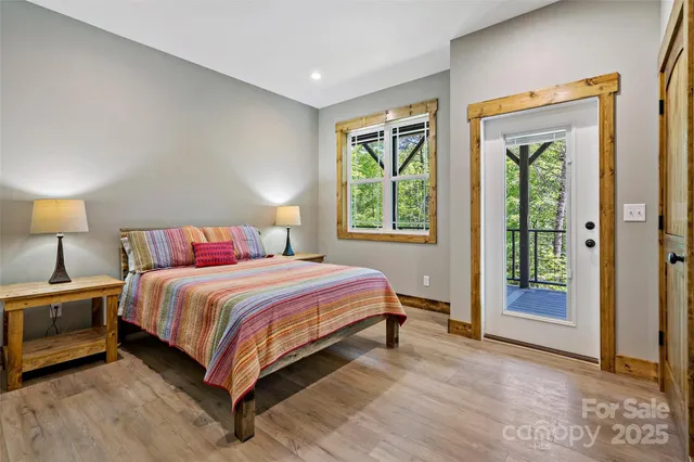 a bedroom with a bed and a large window