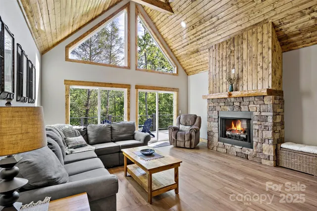 a living room with furniture a fireplace and a large window