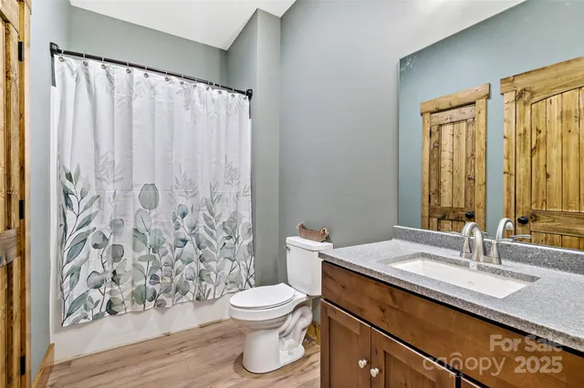 an empty room with windows and cabinet