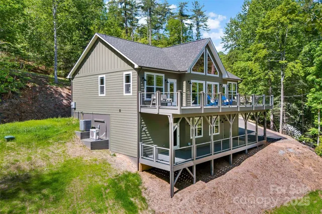 a roof deck with table and chairs under an umbrella