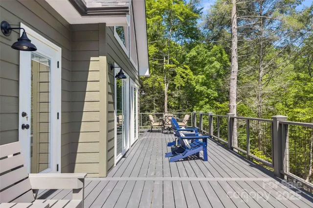 a view of balcony with wooden floor and outdoor seating