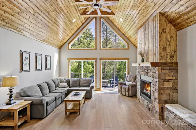 a living room with furniture a fireplace and a large window