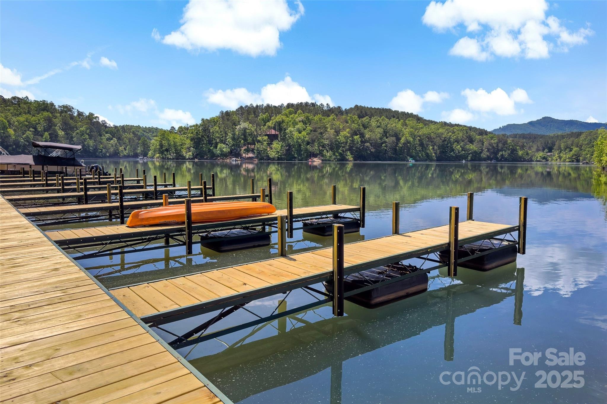23 Laurel Crest Lane Mill Spring, NC 28756 - Photo 43 of 46 a bench sitting in a lake next to a building