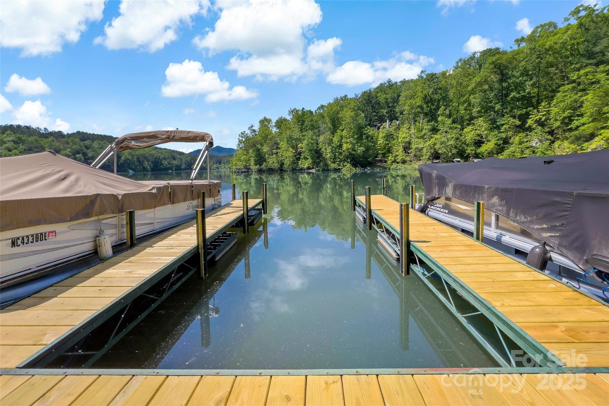 23 Laurel Crest Lane Mill Spring, NC 28756 - Photo 45 of 46 a view of a balcony with two chairs and a wooden fence