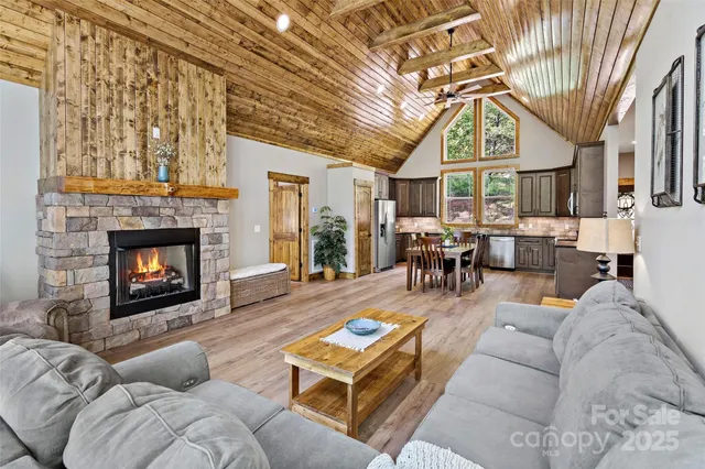 a living room with furniture a fireplace and a chandelier