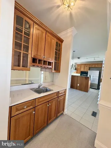 a large kitchen with stainless steel appliances granite countertop a large counter top a stove and a refrigerator