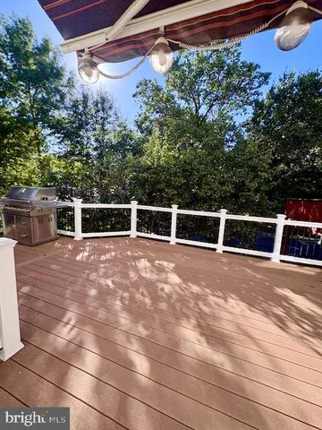 a view of a balcony with wooden floor and iron fence