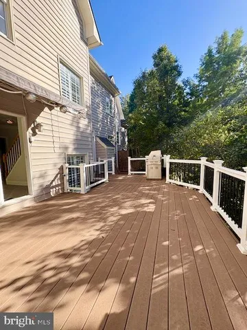 a view of staircase with wooden floor and a large window