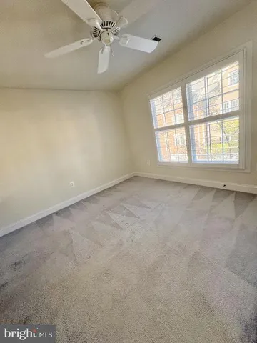 a bathroom with a double vanity sink a toilet and a window