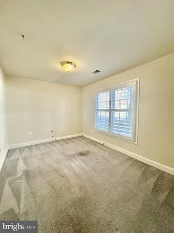 an empty room with a empty space and windows